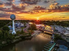 an aerial view of a city with a water tower at sunset