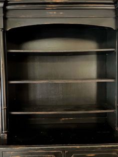 an old black bookcase with two drawers