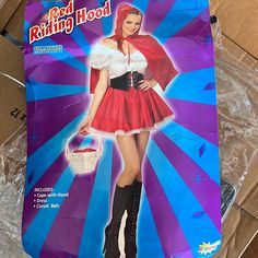 a cardboard box with a woman dressed in a red riding hood and boots on it