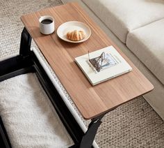 a coffee table with a plate of croissants on it next to a cup of coffee