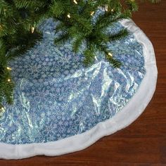 a christmas tree skirt on top of a wooden table