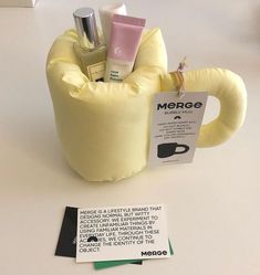 a cup filled with personal items on top of a white table next to a note