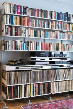 a room filled with lots of different types of records and audio equipment on top of bookshelves