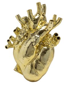 a gold colored heart shaped object on a white background