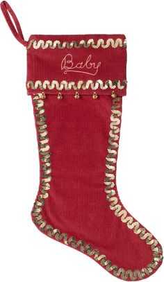 a red christmas stocking with gold trimmings and the word baby on it