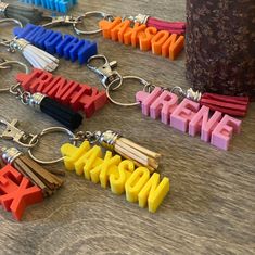 several keychains with the word awesome spelled out in different colors on a table