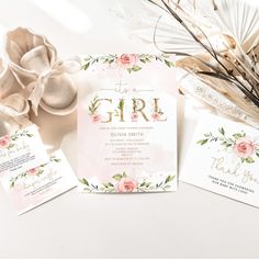 the wedding stationery is laid out with flowers