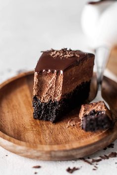 a piece of chocolate cake on a wooden plate