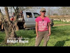 a man standing in the grass next to a tree and truck with words that read animals make us happy