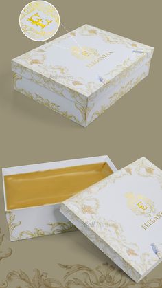 an open white box with gold designs on the lid and inside, sitting on a beige background