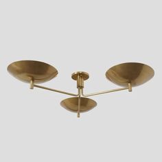 three light brass ceiling fixture with four lights in the middle and one on each side