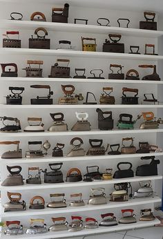 a room filled with lots of different types of old fashioned telephones on shelving