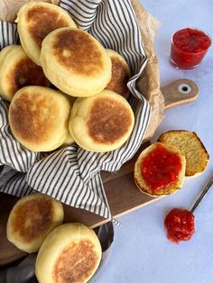 some food is sitting on a plate with bread and ketchup next to it