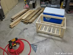 some tools are laying out on the floor next to wood planks and other items