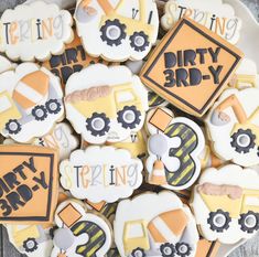 some decorated cookies are on a plate with the words dirty 3rd birthday written in black