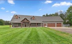 a large house sitting on top of a lush green field