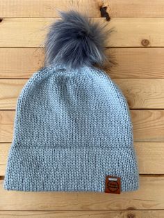 The double brim beanie is a classic. It is simple yet functional. A faux fur pom gives it a modern twist. Care Instructions: Hand wash in cold water on gentle. Lay flat to dry.  Measurements: Approximately 9 inches from crown to brim. Approximately 18 inches around. Can stretch to approximately 20 inches around. Soft Solid Hats For Cold Weather, Soft Hats For Cold Weather, Crochet Boot Cuffs, Crochet Boots, Chunky Knit Throw, Mug Cozy, Boot Cuffs, Knitted Throws, Skull Cap Beanie