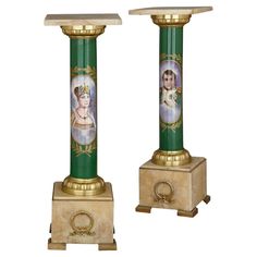 two green and gold pedestals with pictures on them