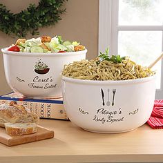 two bowls of pasta and bread on a table