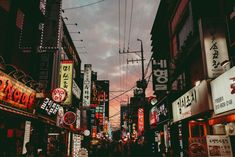 a city street filled with lots of neon signs