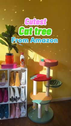 the cat tree from amazon is in front of a yellow wall with colorful shoes on it