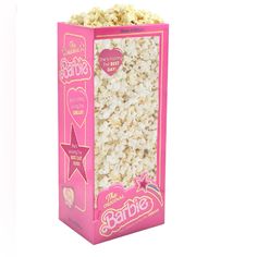 a pink box filled with popcorn on top of a white background