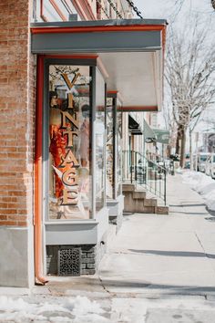 a store front with snow on the ground