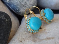 Gold Turquoise Drop Earrings, Turquoise Jewelry, Blue Gemstone Earrings, Reiki Earrings, Rounded Turquoise Earrings, December BirthstoneThese earring have a big wow factor. No one can ignore you when your wear These. They look like they belong to a royal princess of an ancient era. Great for a party or anytime you want to look glamorous and chic.Metal: 24K Gold platedGemstone: Turquoise, SwarovskiLength: 1.4 cm (0.55 Inches)Stone Size: 1 cm (0.4 Inches)The earrings will be packed in a gift box.P Luxury Turquoise Oval Earrings, Turquoise Earrings Studs, Bohemian Turquoise Earrings With Gemstone Accents, Turquoise Gemstone Drop Earrings, Turquoise Drop Earrings With Gemstone Accents, Turquoise Earring, Blue Gemstone Earrings, Lapis Jewelry, Turquoise Stud Earrings