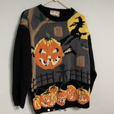 an ugly sweater with pumpkins and bats on it