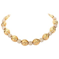 This Ambrosi designer necklace was inspired by an orbital and elliptical motif and crafted in fine 18K yellow gold. 14 individual links are fashioned into elliptical and fantasy shapes while 14 spherical-shaped diamond globes serve to connect them. With such movement and fluidity in this piece, the sparkle and glisten allows it to be a stand alone piece of jewelry for the evening. Remarkable filigree carved plates adorn the reverse of every part fo this choker. Diamonds collectively weigh appx.20.30 carats and are graded as appx. F-G color and VS clarity. Measures appx. 16.25mm x 15 Inch Hallmarked Ambrosi and purity marked. Secures with a hidden insert clasp and flip safety. Necklaces Choker, Vintage Choker Necklace, Vintage Choker, Designer Necklace, Gold Choker Necklace, Gold Choker, Choker Necklaces, Link Necklace, Necklace Designs