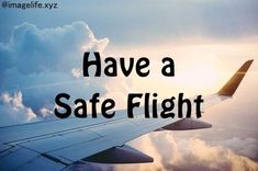 an airplane wing with the words have a safe flight above it and clouds in the background