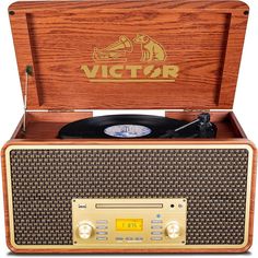 an old fashioned wooden record player with the word victory on it's front and side