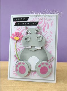 a birthday card with a hippo holding a flower