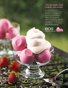 some pink and white marshmallows are in a glass bowl on a table