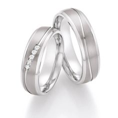 two white gold wedding rings with diamonds on each one and the other side, set in 18k white gold