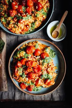 two bowls of pasta with tomatoes and broccoli next to a bowl of pesto