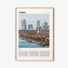 the tampa skyline as seen from across the water in front of a white wall with a wooden frame