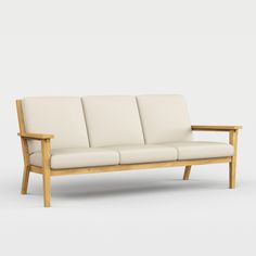 a white couch sitting on top of a wooden frame