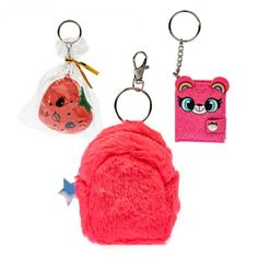 two keychains with different designs and colors on them, one has a pink bear