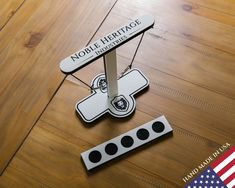 a wooden floor with a sign that says noble heritage center on it and an american flag in the background