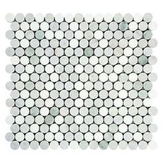 a white and black mosaic tile with circles on the bottom, in various sizes and colors