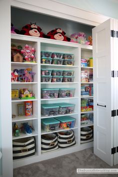 the closet is full of toys and other items in it's storage area,