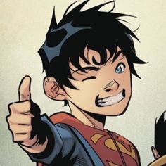 a young man in a superman costume giving the thumbs up