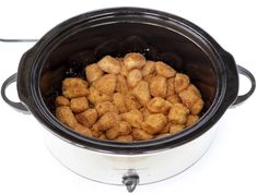 a crock pot filled with tater tots sitting on top of a table