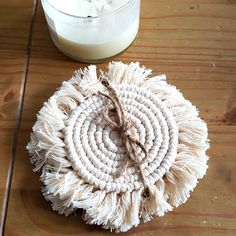 a round white object sitting on top of a wooden table next to a glass of milk