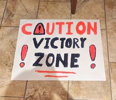 a sign that says caution victory zone on it