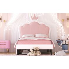 there is a pink bed with white sheets and teddy bears on the floor in front of it