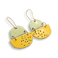 You will get a ton of compliments when you wear these pale green and buttercup yellow enamelled earrings.  Jewellery meets art! These lightweight, unusual earrings come with high quality hand formed brass ear wires that clasp so you never have to worry about losing them. What is enamel?   Enamel is made by fusing multiple layers of glass to a prepared metal at a very high heat.  Each earring requires between four to 10 layers of enamel depending on the effect I'm going for.   To make these earri Hand Painted Yellow Enamel Earrings, Unique Yellow Pierced Earrings, Unique Yellow Earrings, Yellow Enamel Earrings, Unusual Earrings Unique, Enamel Jewellery, Buttercup Yellow, Jewellery Art, Unusual Earrings