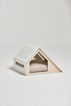 a white cardboard house with a bed inside