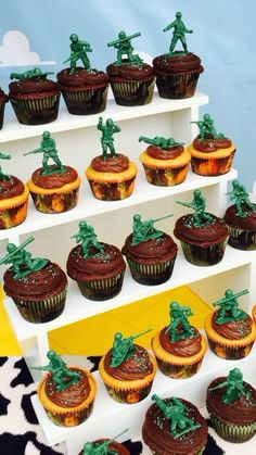 cupcakes with chocolate frosting and toy soldiers on top